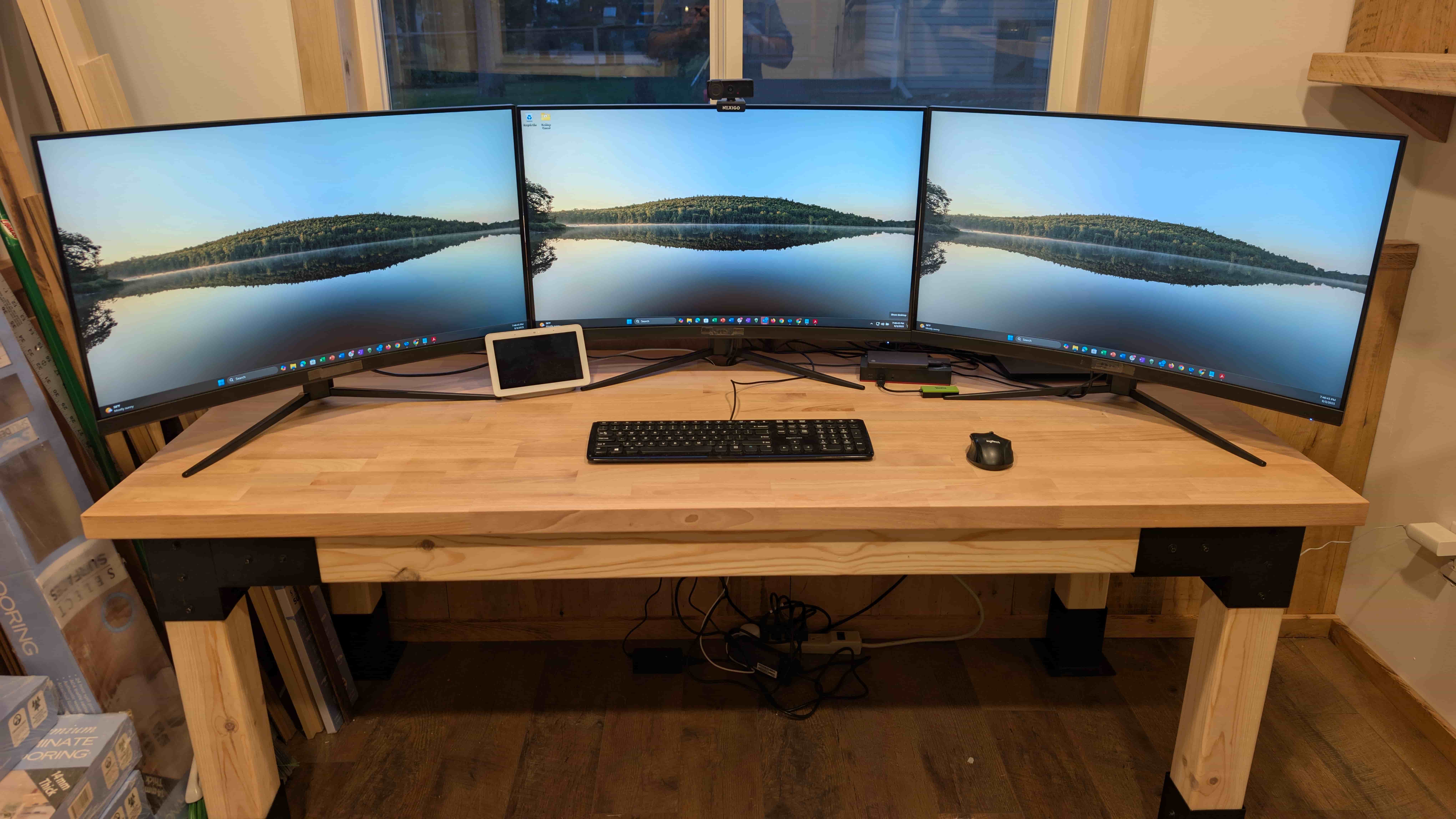 Three-monitor setup on a handmade butcher block desk