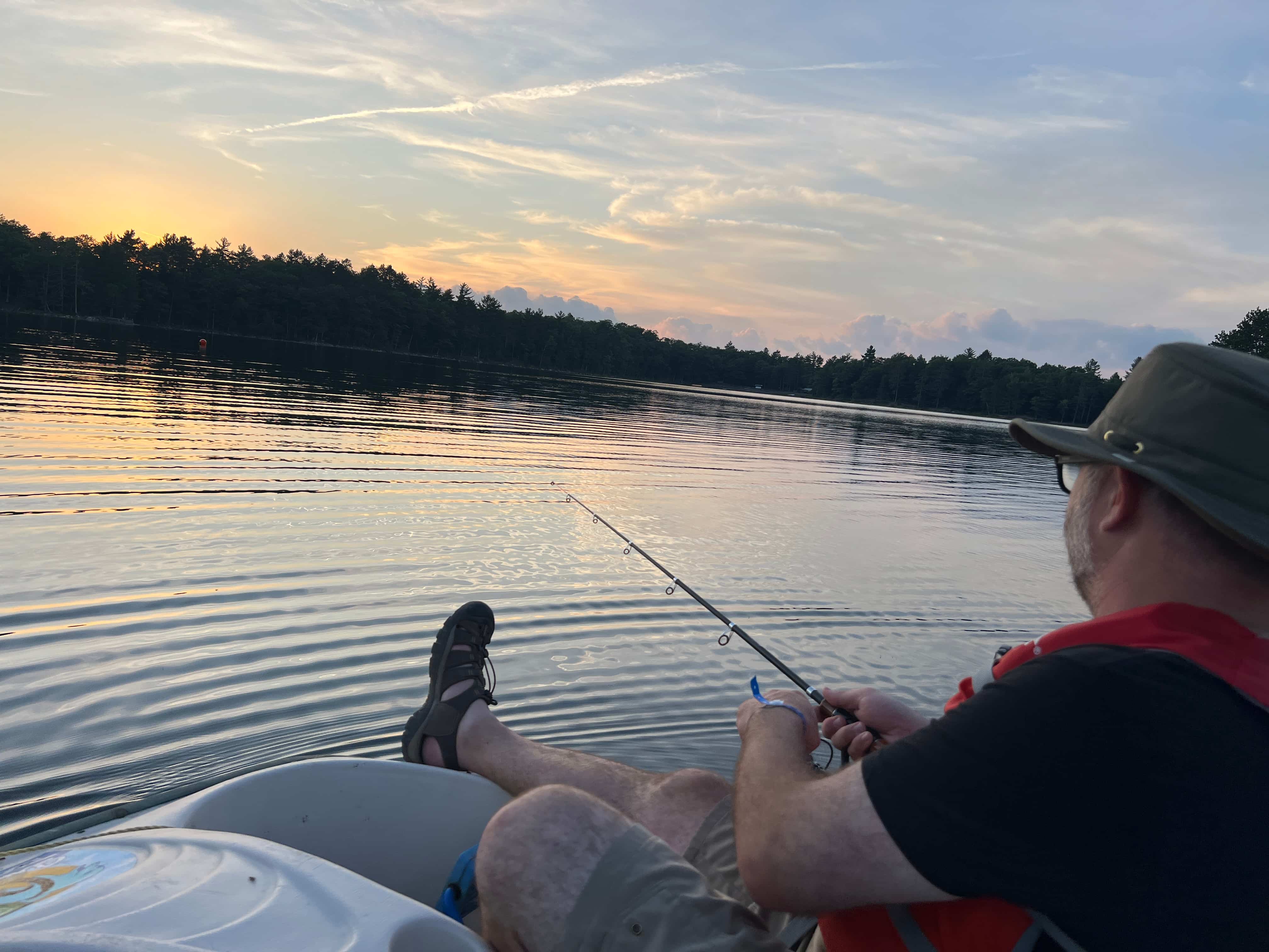 Fishing from a kayak at sunset