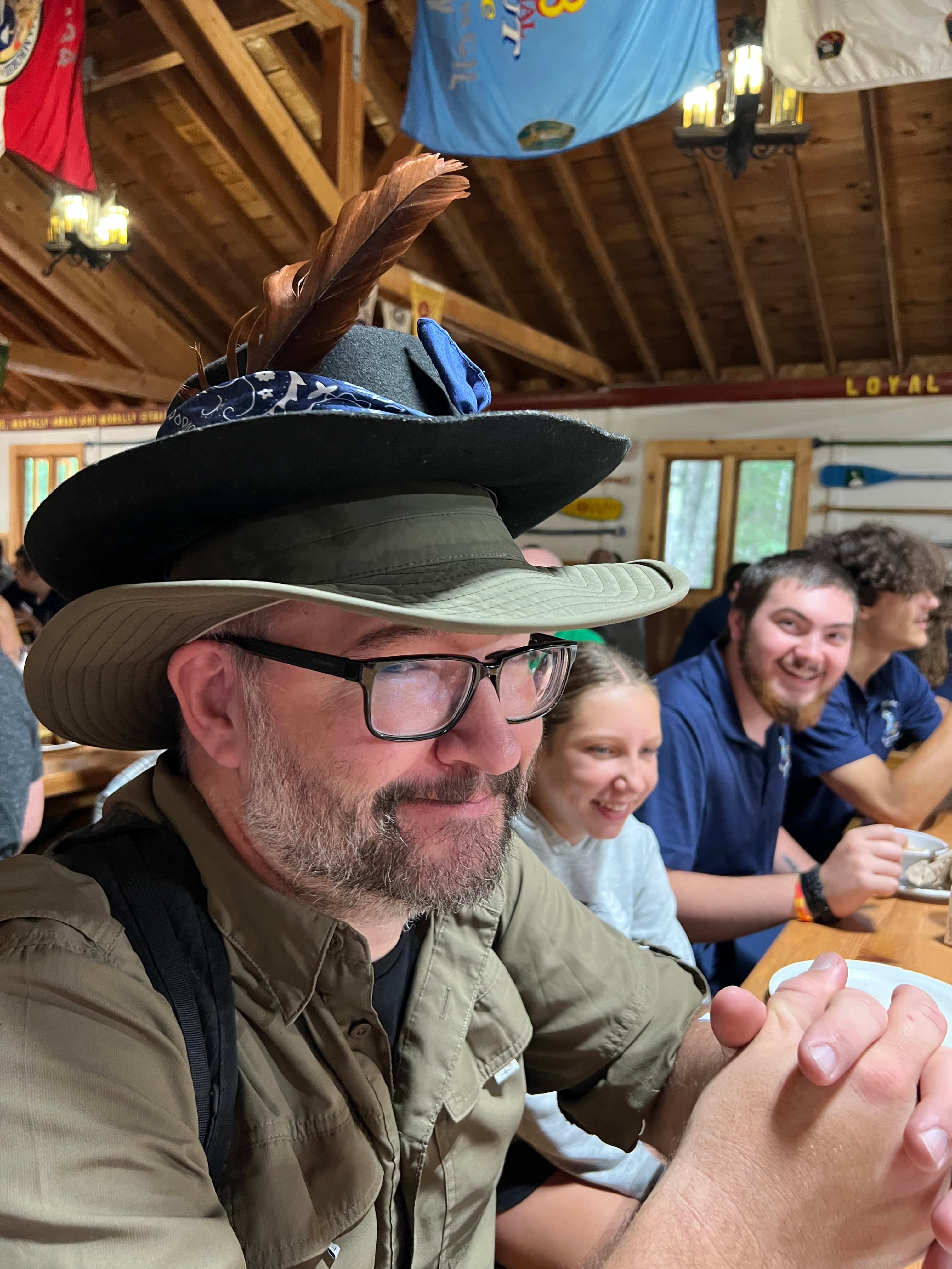 Wearing a feathered camp hat at Scout dining hall