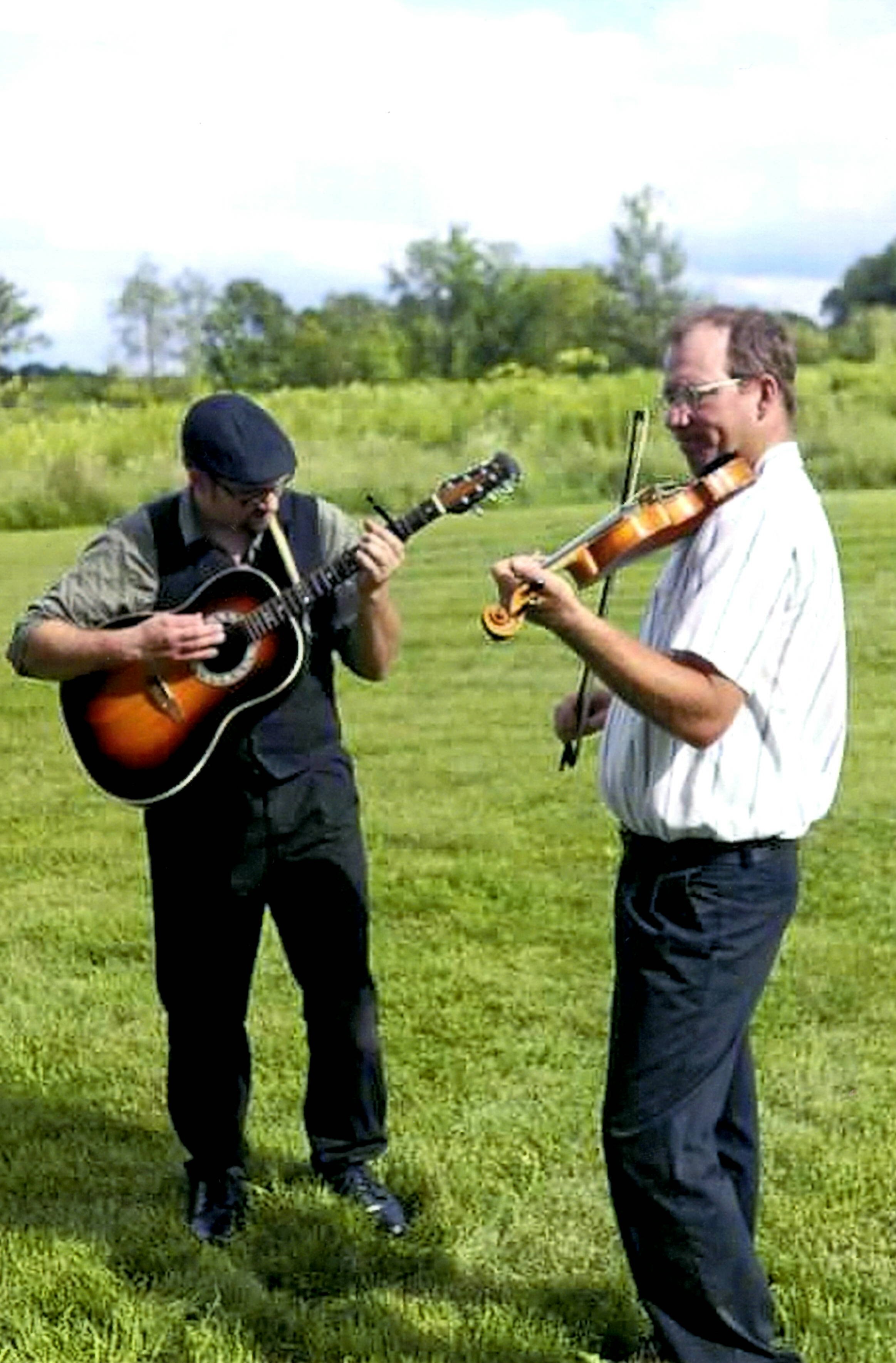 Playing guitar in a field